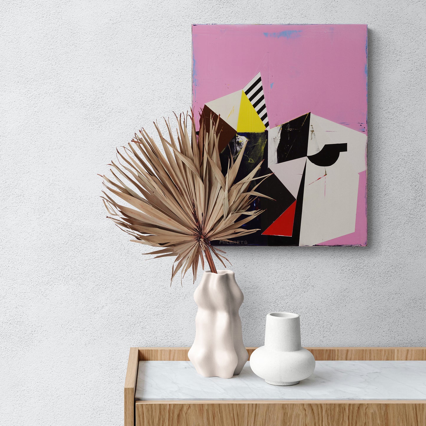 Abstract painting on a wall with decorative vases and dried plant