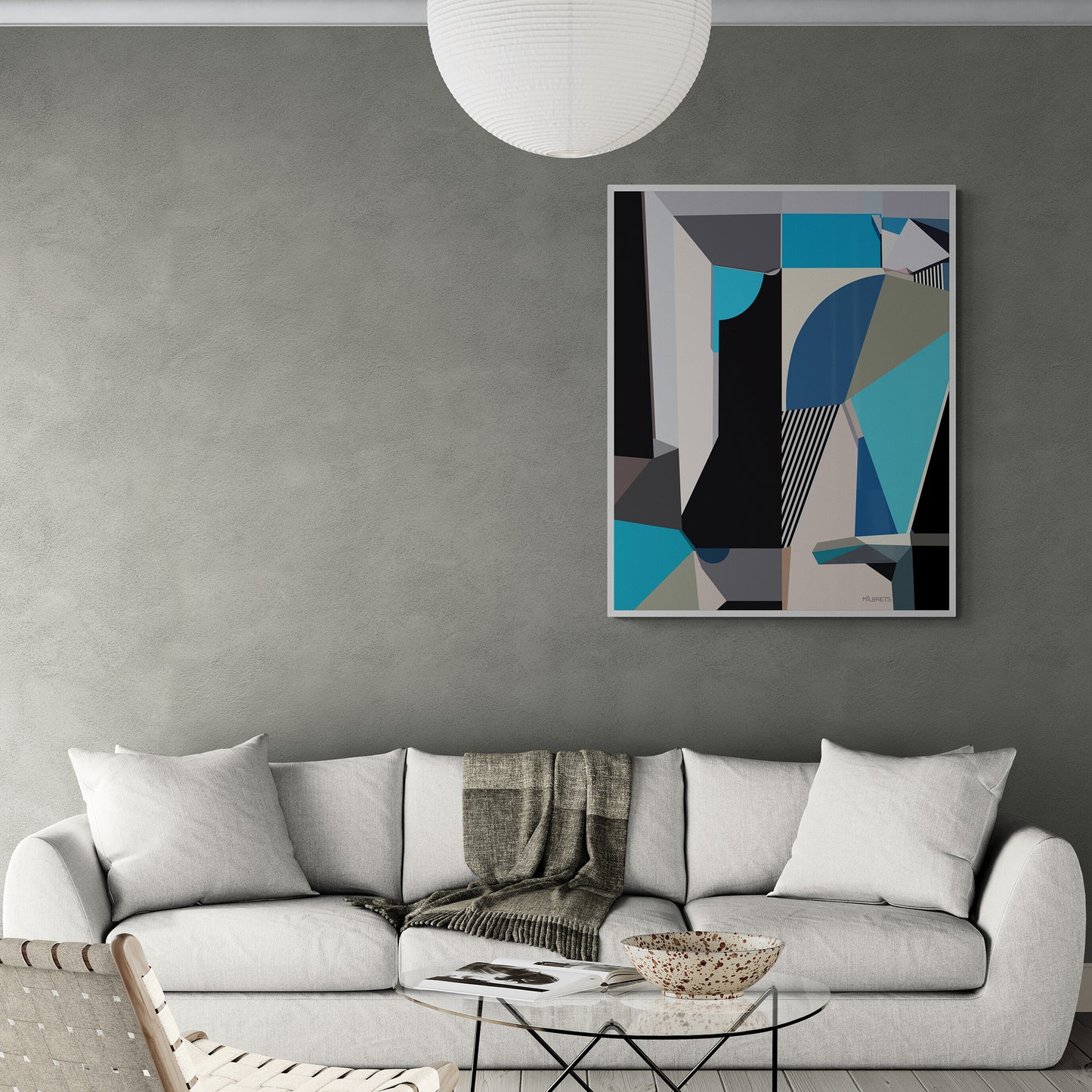 Modern living room with a gray sofa, blue abstract art on the wall, and a white pendant light.