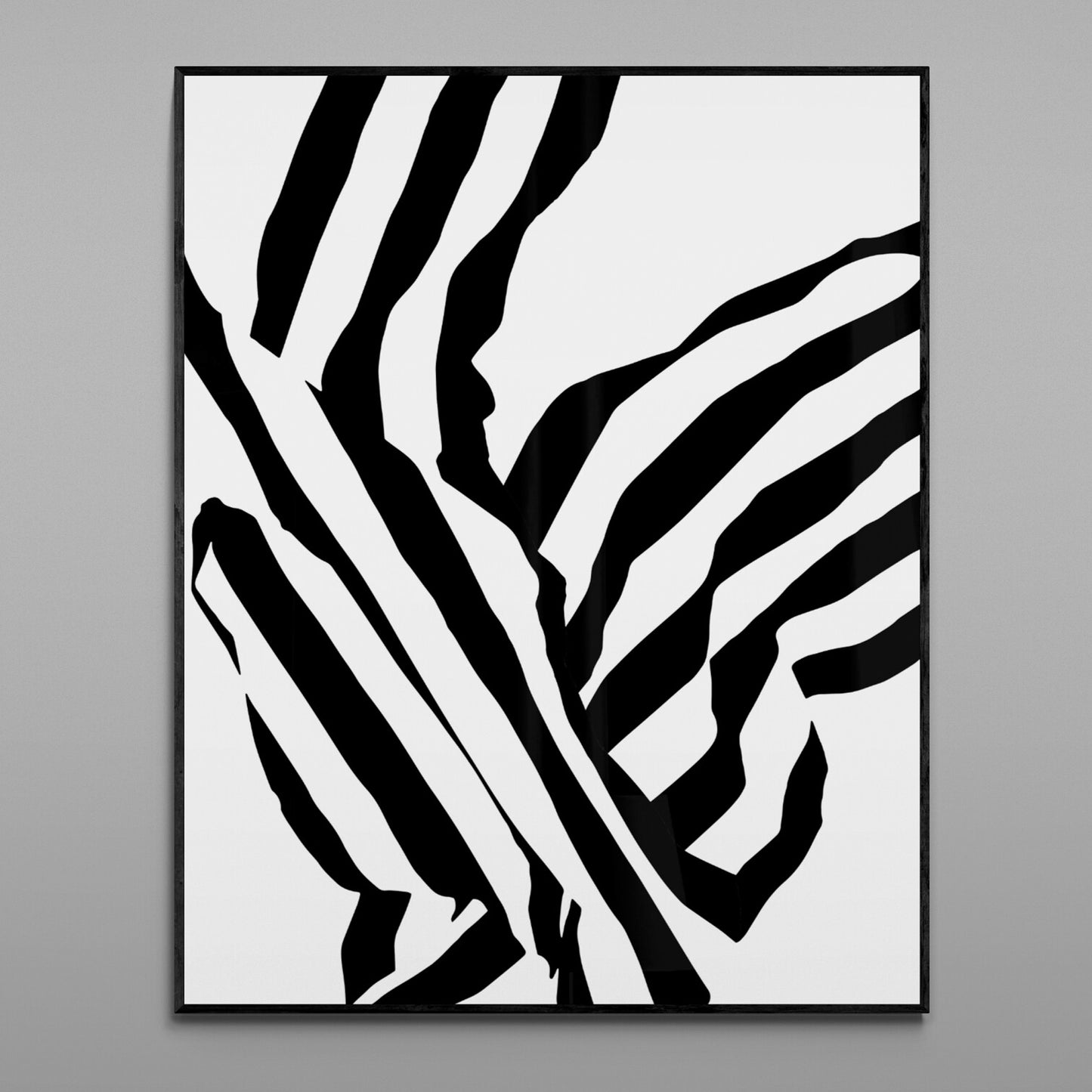 Framed black and white abstract art on a gray wall
