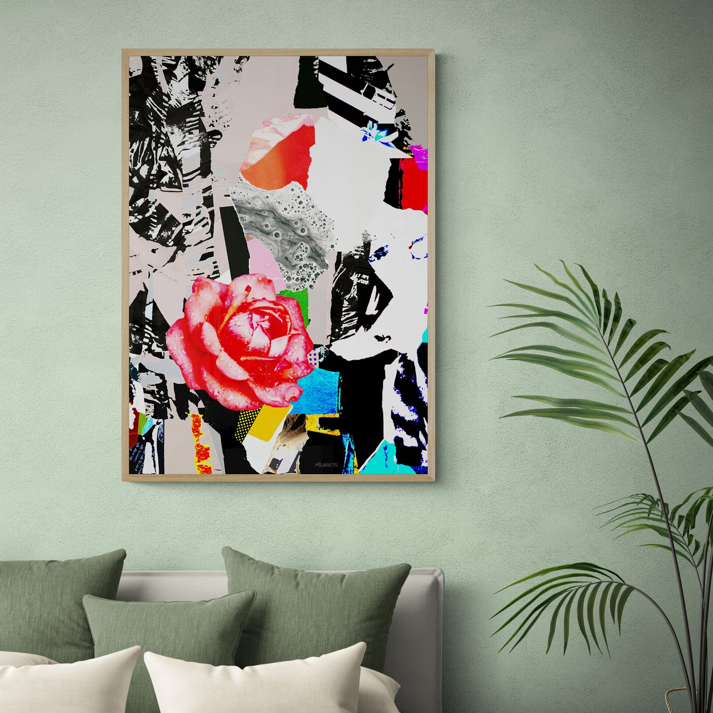 Colorful abstract floral art piece on a green wall with a plant and pillows below.