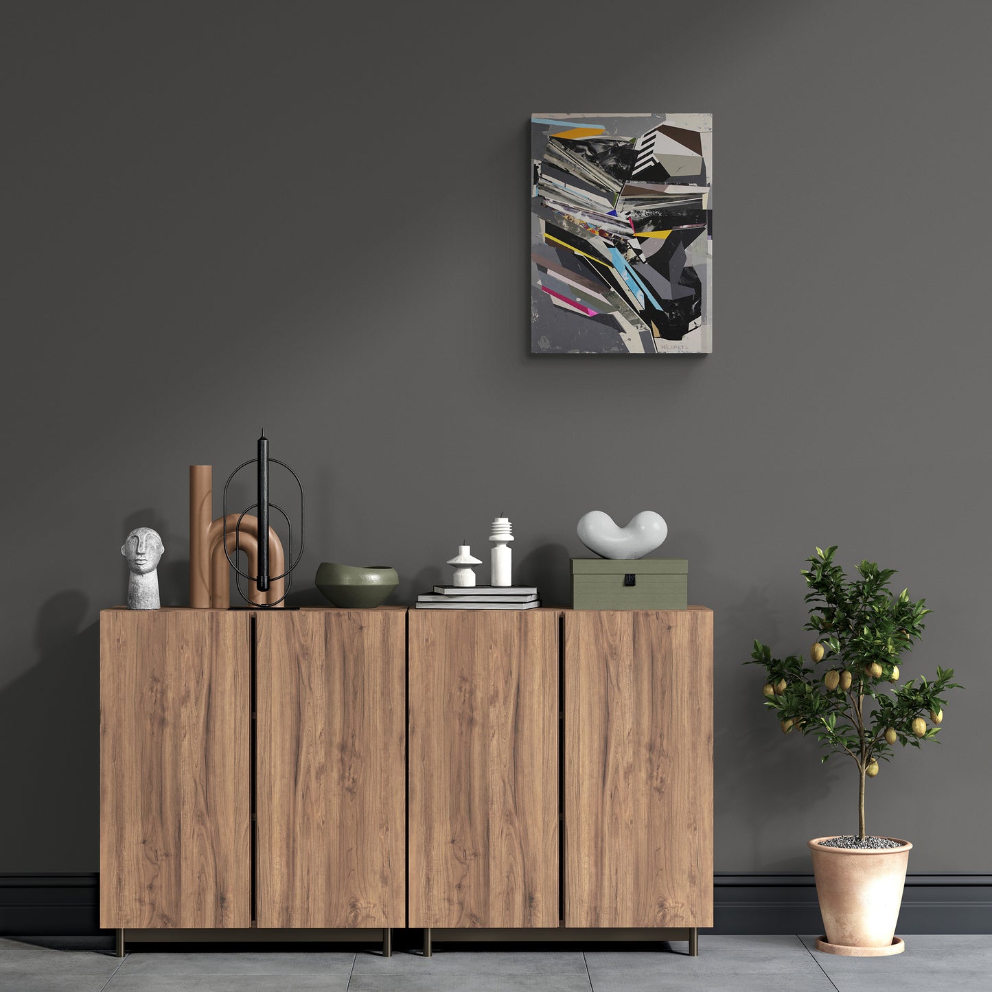 Wooden sideboard with decorative items against a dark gray wall with a abstract painting.