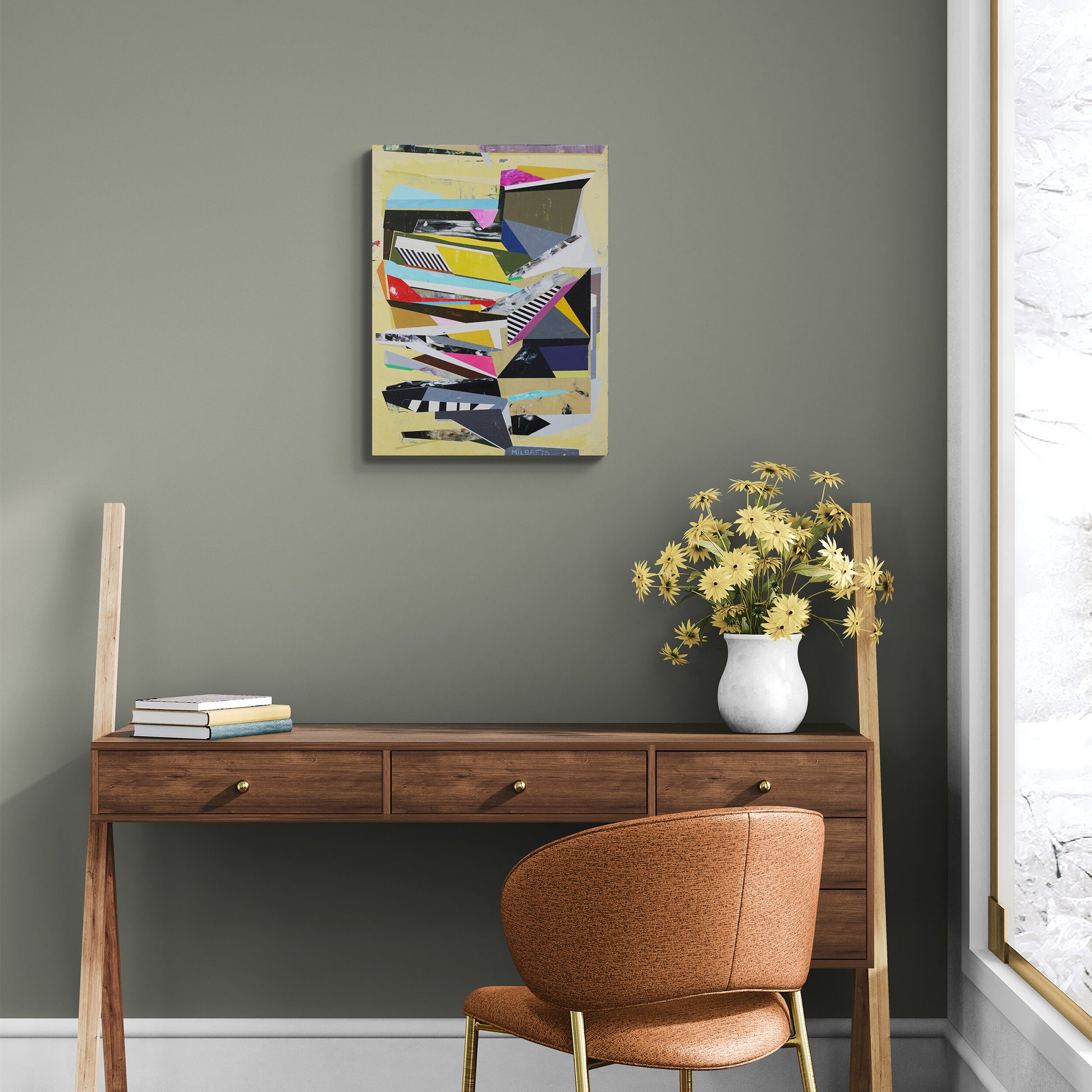Wooden desk with a chair against a gray wall with a colorful abstract painting.