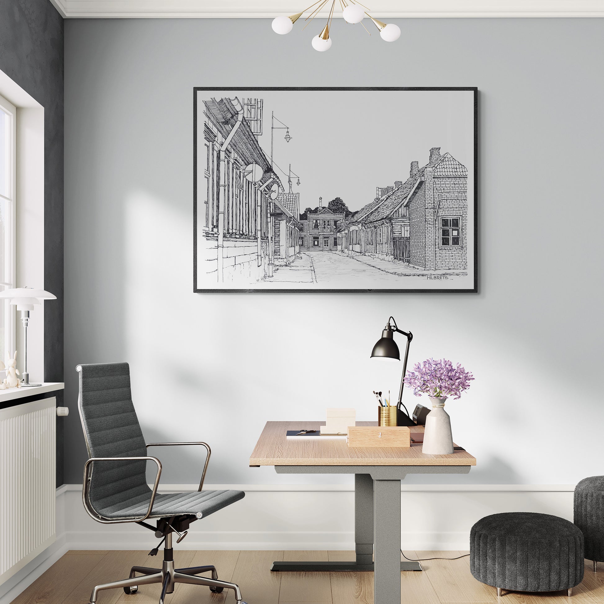 Modern office space with a desk, chair, and framed artwork on the wall.