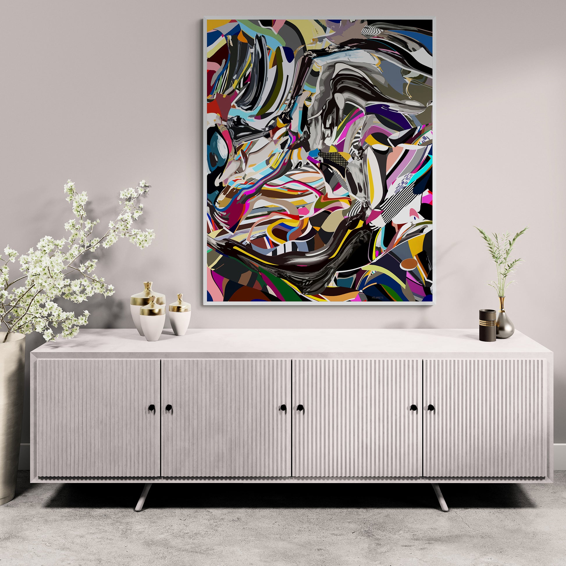 Abstract artwork on a wall above a white cabinet with decorative items.