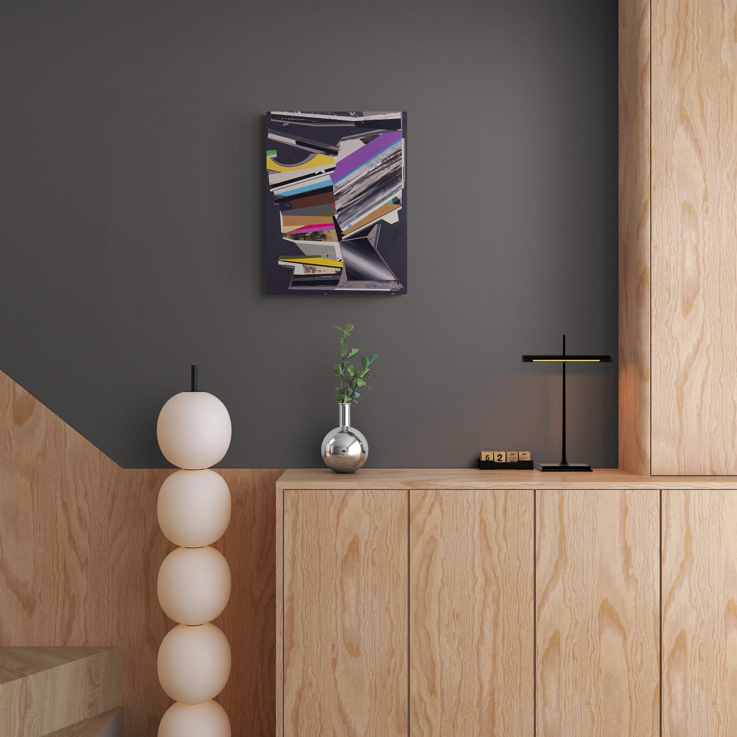 Modern interior with wooden cabinet, decorative items, and abstract art on a gray wall.