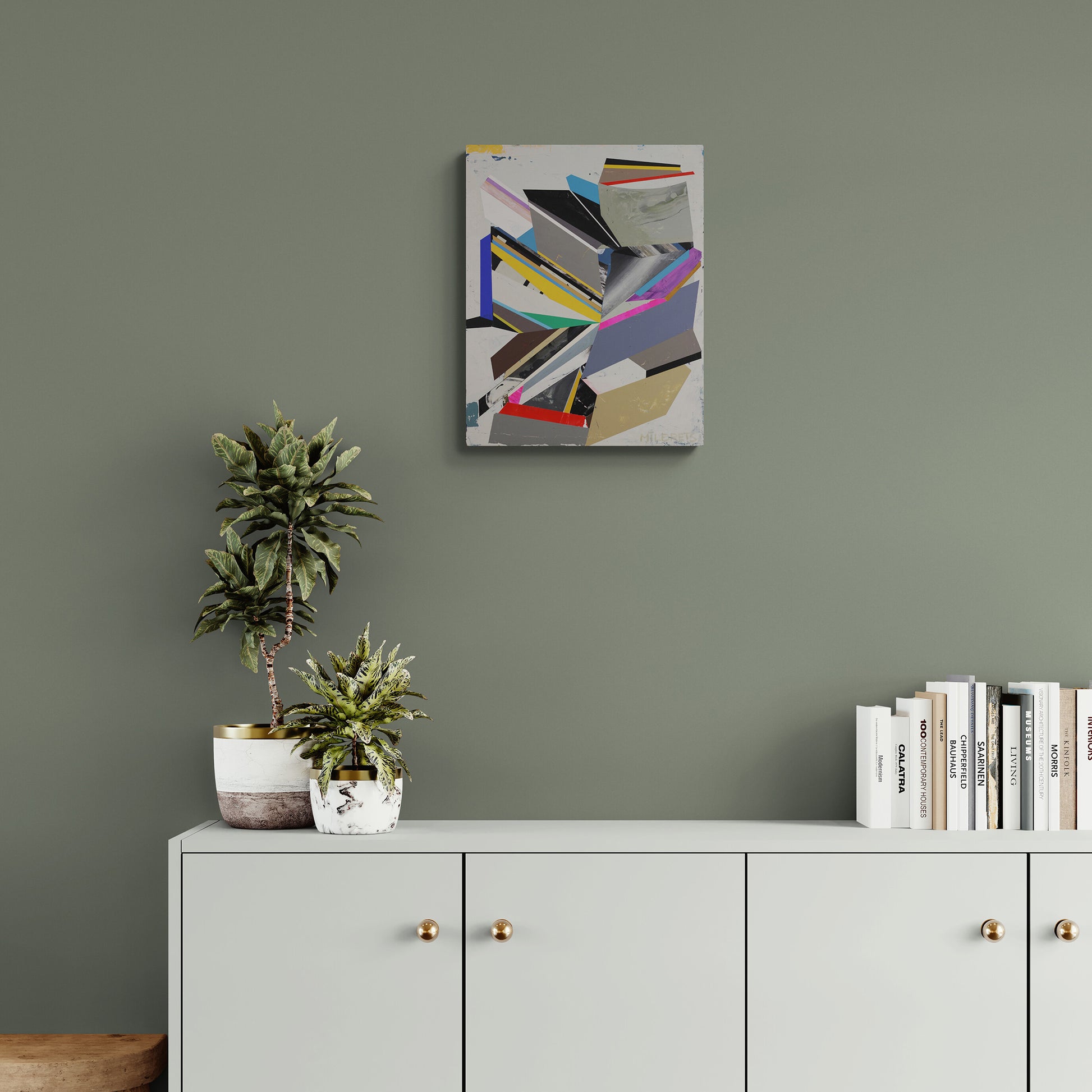 Modern interior with a cabinet, plants, and abstract art on a gray wall.