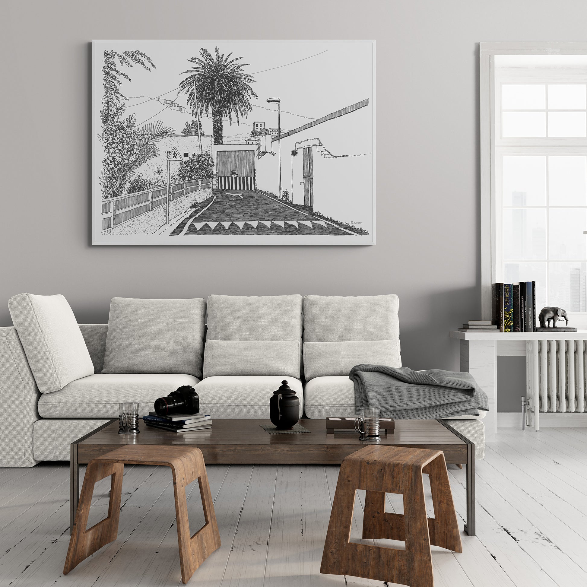 Modern living room with a gray sofa, wooden coffee table, and tropical canvas print on the wall.