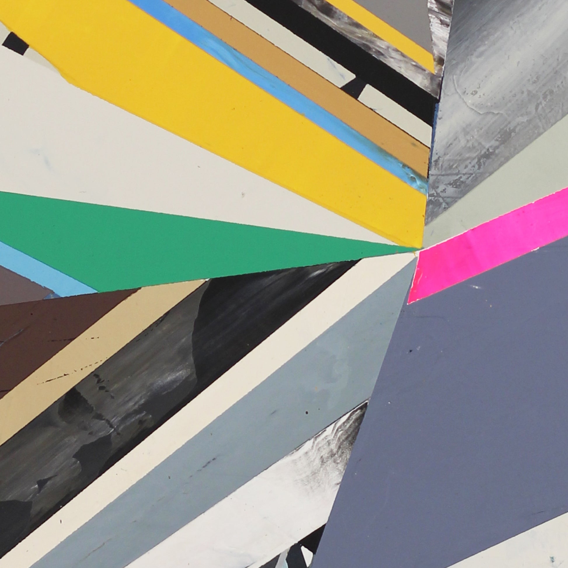 Detail of an abstract art piece with geometric shapes in various colors on a textured surface.